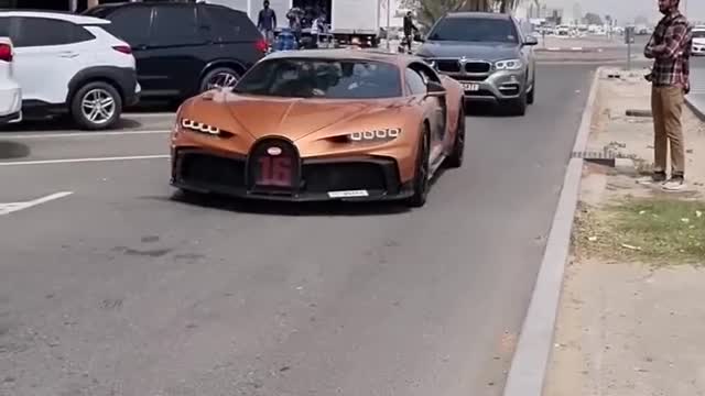 Top G driving his Bugatti