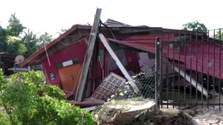 Malaysians survey the damage after devastating floods