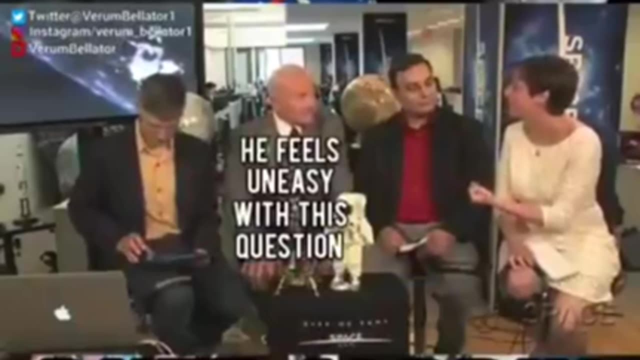 Buzz Aldrin spilling the beans while his handler tries to keep him in check