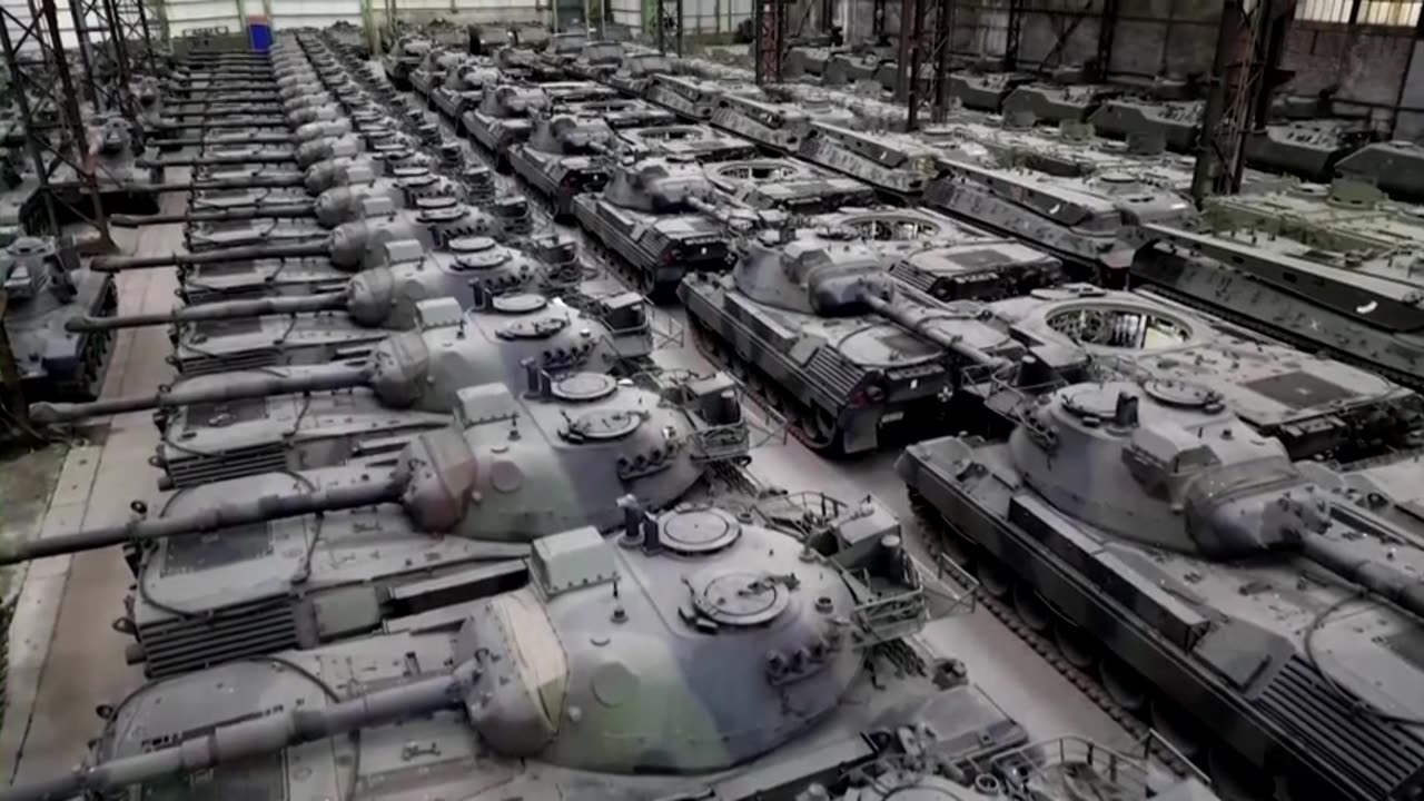 Big warehouse full of second-hand tanks for sale.