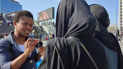 Christian lady talks to two shy Muslim girls