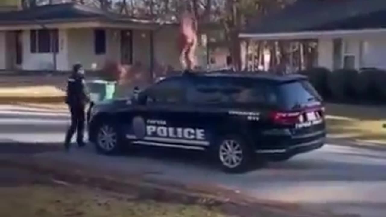 Black woman , naked, resisting arresting, singing