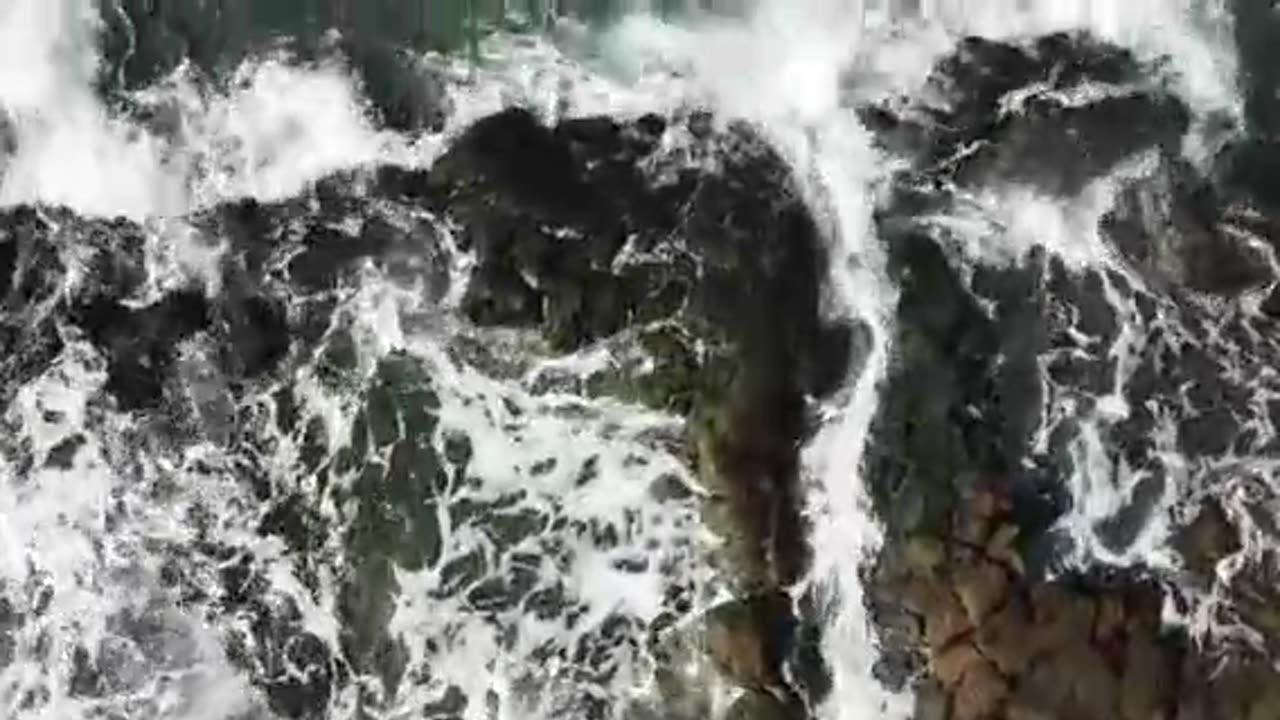 Top View of Breaking Waves on a Rocky Shore