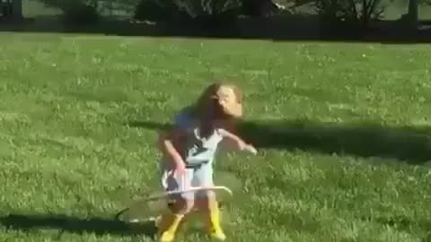 Cute funny girl plays in the garden