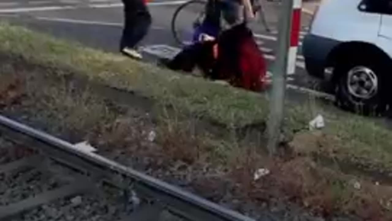 A business owner tries to deal with climate activists blocking a road in Cologne, Germany.