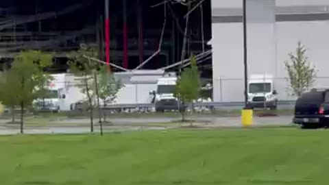 The footage depicts a tornado causing extensive damage to a FedEx facility in Portage, Michigan.