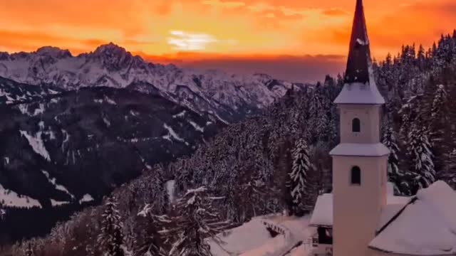 When fiery orange skies contrast against snow-blanketed landscapes. 🔥
