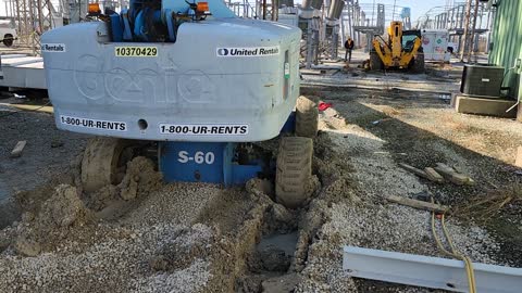 Forklift, manlift, stuck in the mud inside of a substation.