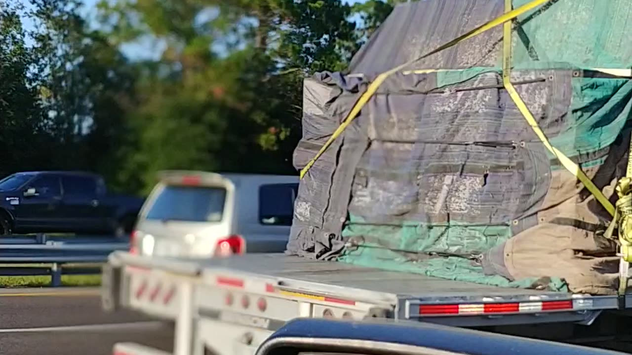 Hauling Bee hives down the highway headed West Honey Bees used to pollinate avocado trees in Cali