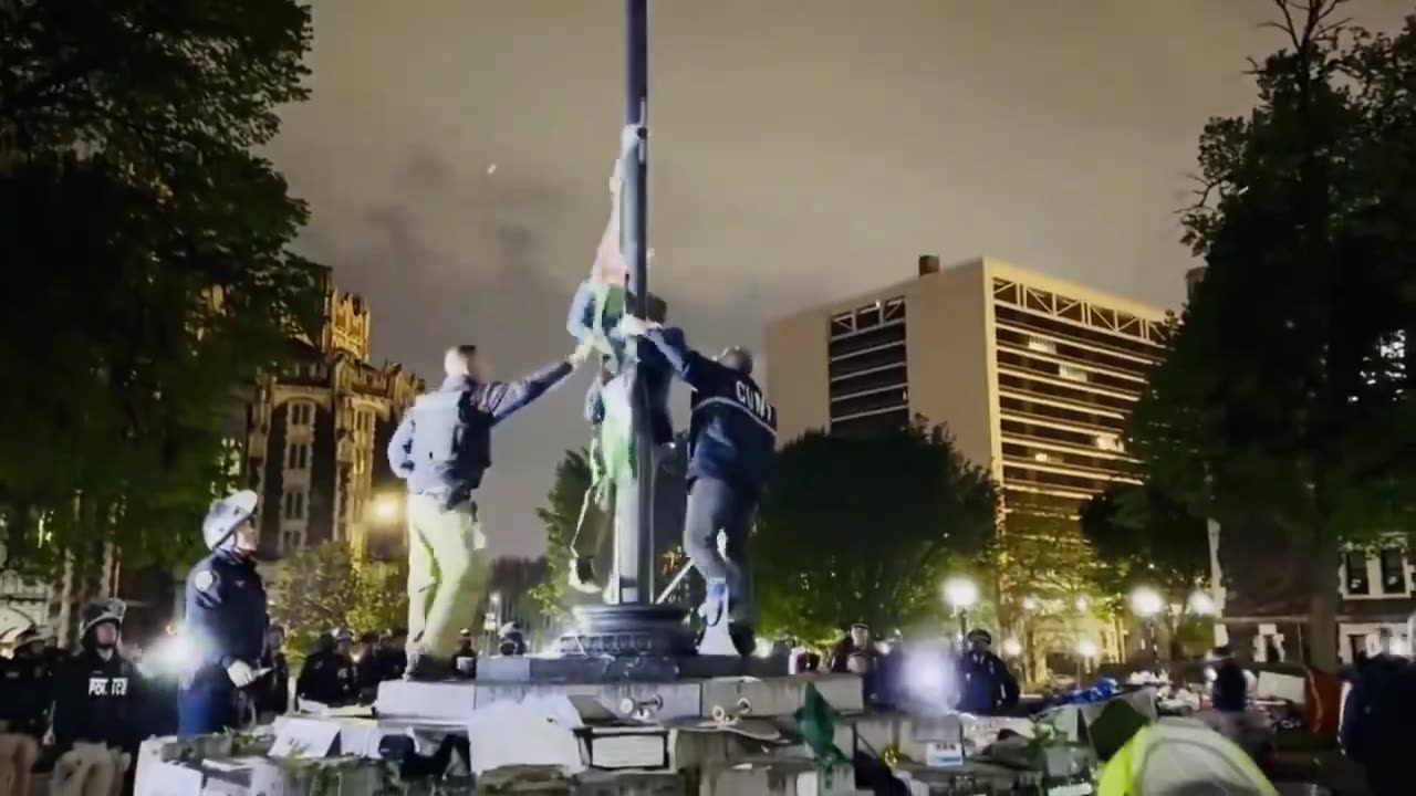 The NYPD takes down a Palestine flag at City College of NY, replacing it with the American flag