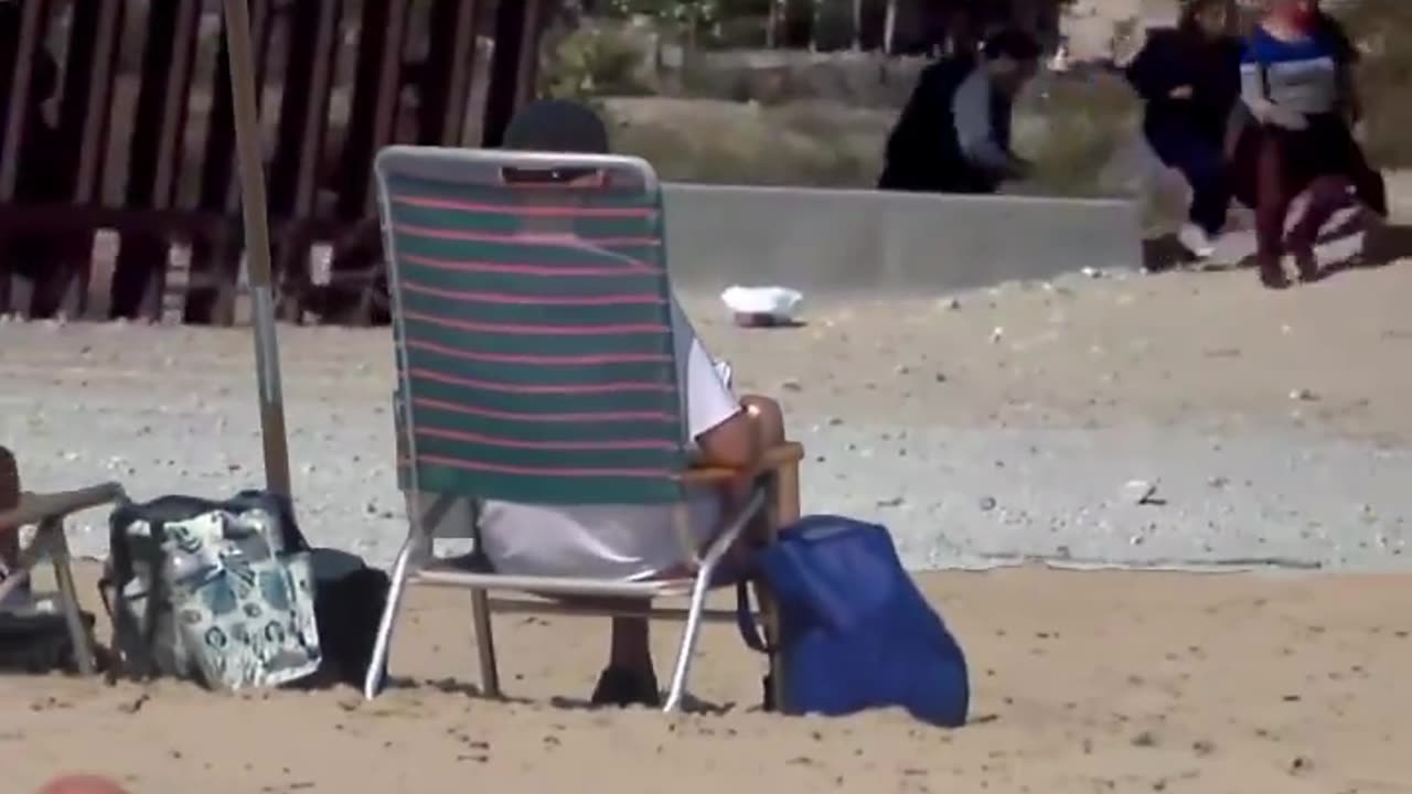 Crooked Joe vacations on the beach 🏖️ while they flood into the country 🌊🚶♂️