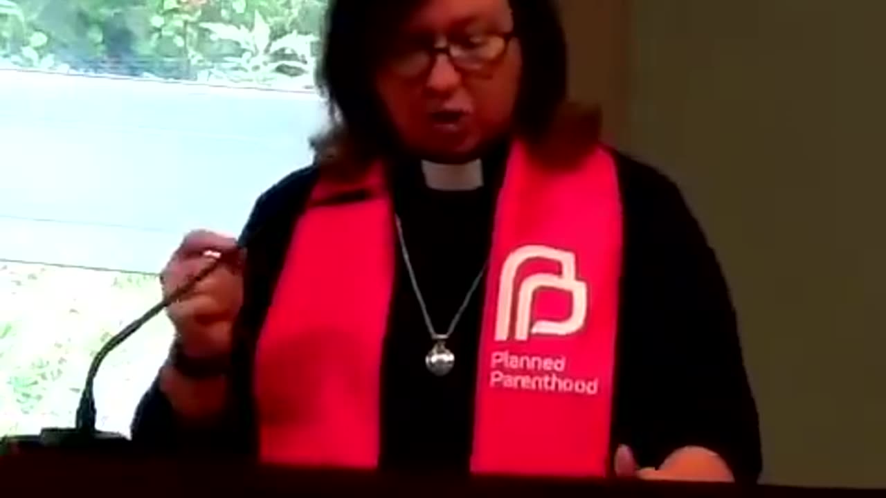 Female "pastor" praises abortions while wearing a Planned Parenthood sash.