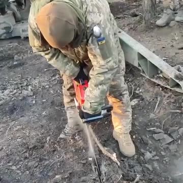 Cutting into the Frozen Ground with a Chain Saw
