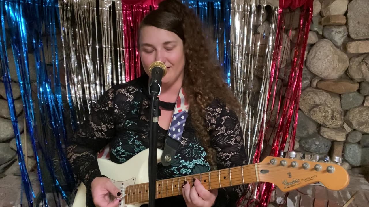 Becca Murder sings through her microphone Slightly Scary Music