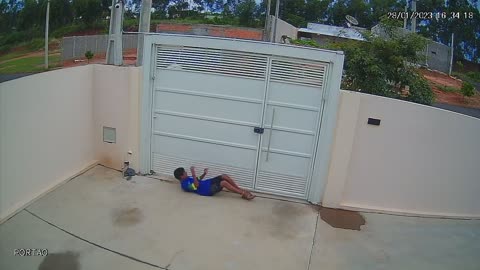 Boy Sneakily Squeezes Under Gate