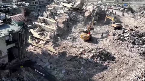 Excavators demolish damaged buildings in Turkey