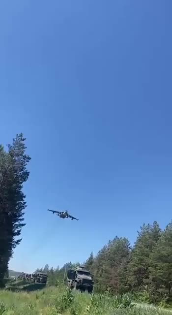 Russian SU-25 flying low above a Russian Military column