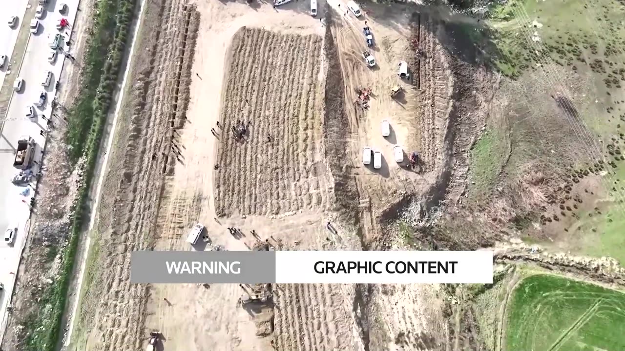 Drone shows mass grave for hundreds of quake victims