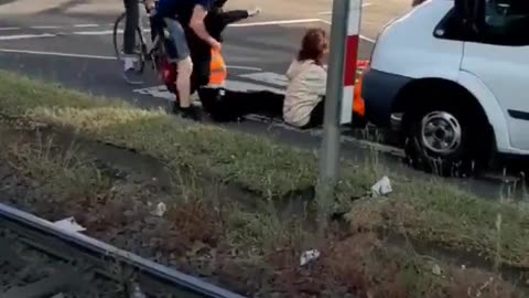 A business owner tries to deal with climate activists blocking a road in Cologne, Germany.