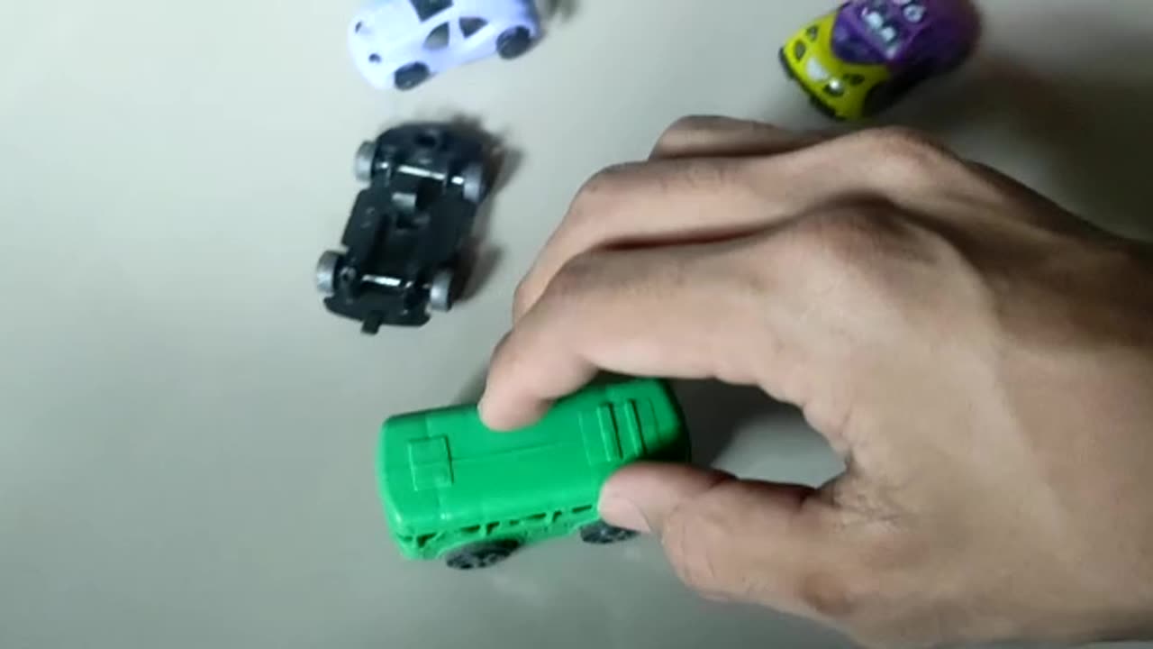 playing a green bus car toy