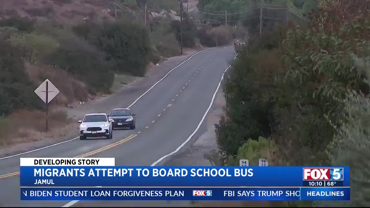 Migrants attempt to board school buses in East County