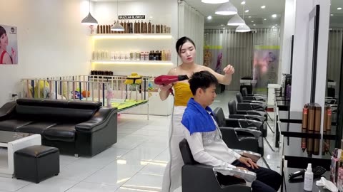 Relaxing shampoo and massage service at Vietnamese barbershop with beautiful girl