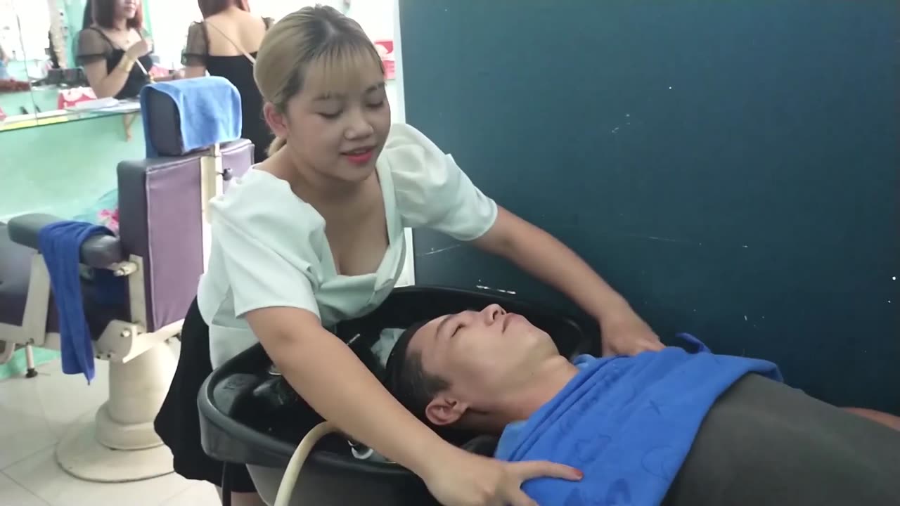 Beautiful and talented girl, relaxing shampoo and facial massage at Vietnam Barber shop