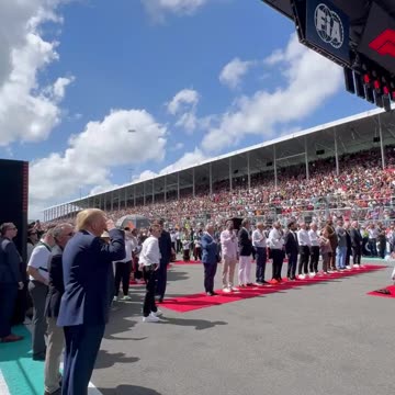 Donald Trump salutes to the National Anthem on Formula1 Pit Lane
