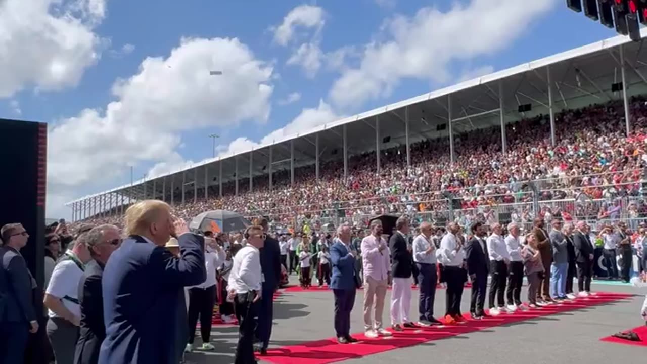 Donald Trump salutes to the National Anthem on Formula1 Pit Lane