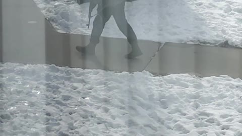 Man Circles Apartment Building With Firearm
