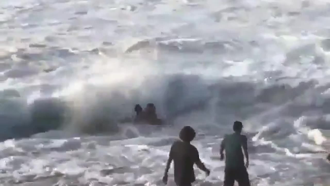 Mikey Wright rushes into the Hawaiian sea to rescue a struggling swimmer