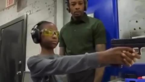 Father teaches his son how to safely and correctly use a handgun, firearm safety and good parenting