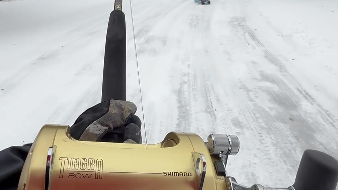 Woman Goes Sledding With Boogie Board And Fishing Pole