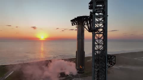 SpaceX successfully captures reusable rocket booster with catch tower.