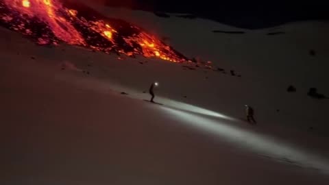 Mount Etna is erupting with its summit covered in snow