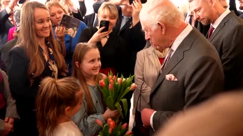 King Charles visits Polish center as Prince William visits charity