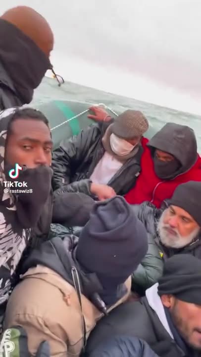 migrants on boats with phones...