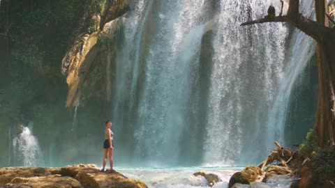 A powerful waterfall cascading into a serene lake