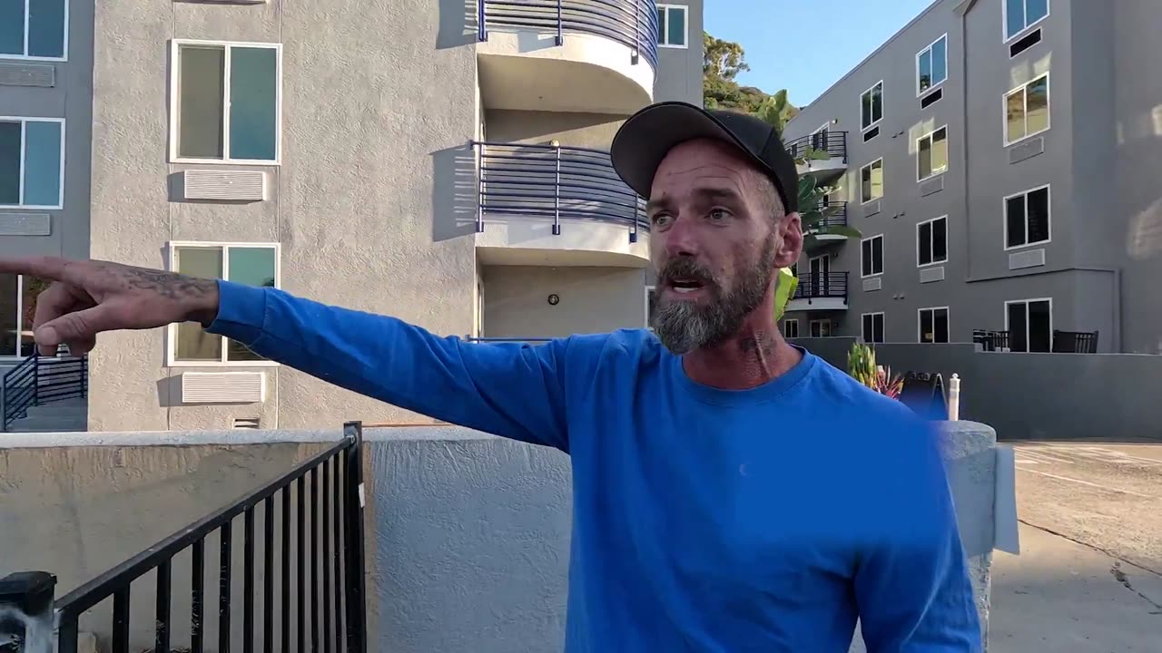 Man works where he overlooks a migrant hotel in San Diego, California