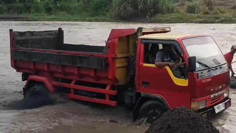 the truck is loading river sand