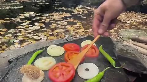 Sea bass grilled on hot stones in nature