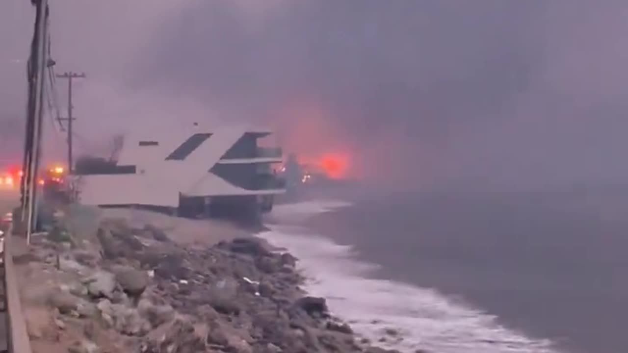 As the sun begins to rise, fires continue to rage on homes on the Malibu coast.