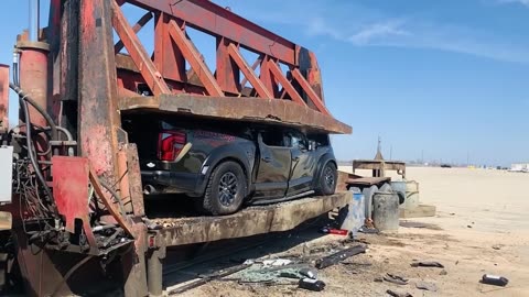 Truck crushed by hydraulic pressing machine in scrap yard