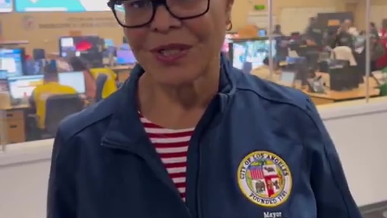 Mayor Karen Bass smiles while praising fire fighters, first responders for battling fires.