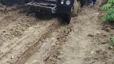 trucks stuck on muddy roads barely able to pass