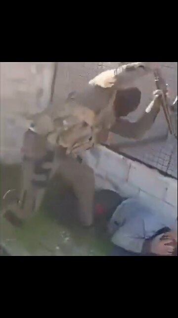 Syrian "Moderate" black ski-masked Terrorist beating man with butt of Rifle