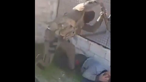 Syrian "Moderate" black ski-masked Terrorist beating man with butt of Rifle