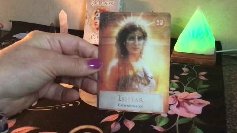 A Libra Tarot Reader reading a card from the Goddess Power Oracle Deck