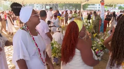 Brazilians honor sea goddess and mark arrival of new year with dance and drums in Rio de Janeiro