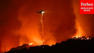 Firefighting Helicopters Drop Water On Fire As The Wildfires Continue To Burn In Los Angeles